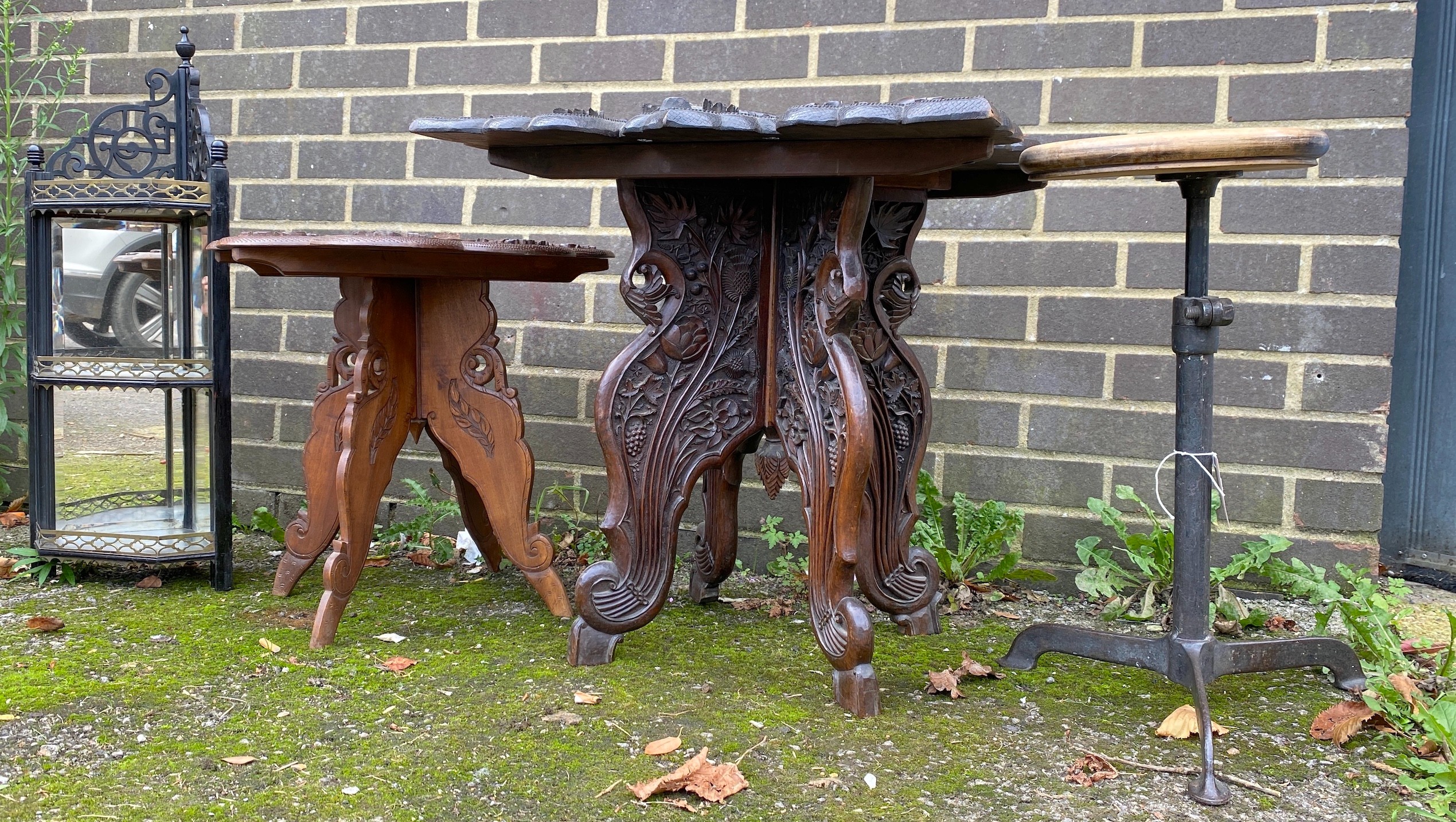 Two Indian carved hardwood occasional tables, a Victorian ebonised corner wall bracket and an industrial stool